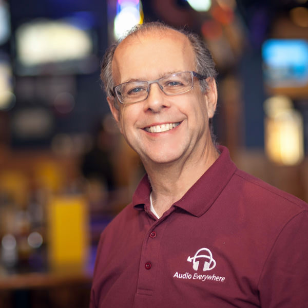 Founder in branded polo at a venue, early product era